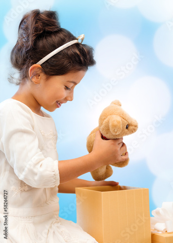 Photo: happy child girl with gift box and teddy bear happy child girl with gift box and teddy bear