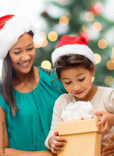 Photo: happy mother and child girl with gift box happy mother and child girl with gift box