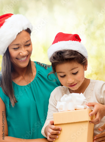 Photo: happy mother and child girl with gift box happy mother and child girl with gift box