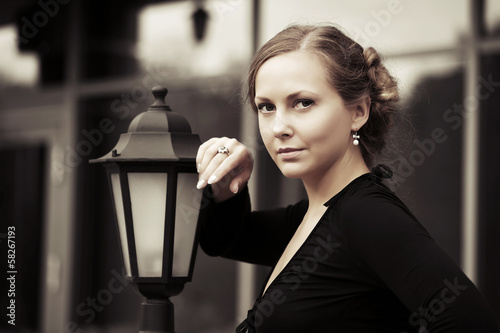 Photo: Beautiful woman at lamppost Beautiful woman at lamppost
