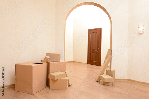 Photo: Empty room with stack of cartons: moving house concept Empty room with stack of cartons: moving house concept