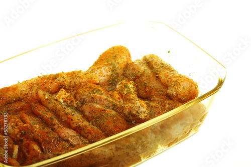 Photo: Closeup raw marinated chicken meat drumstick Closeup raw marinated chicken meat drumstick