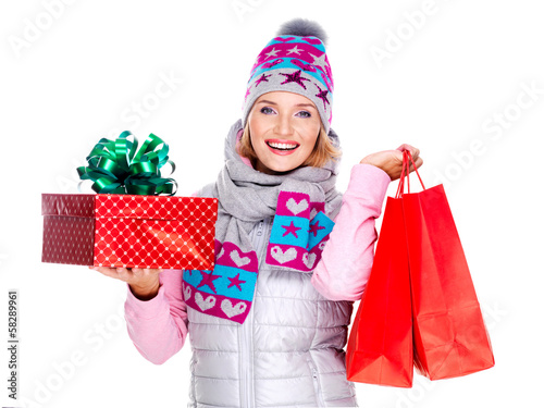 Photo: Happy woman with gifts after shopping to the new year Happy woman with gifts after shopping to the new year