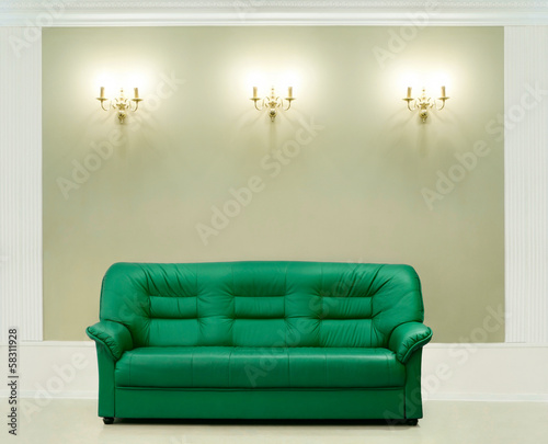 Photo: The green leather sofa, is put about a wall with candelabrums The green leather sofa, is put about a wall with candelabrums