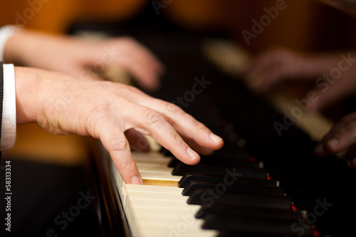 Photo: Hands playing the piano (close-up) Hands playing the piano (close-up)