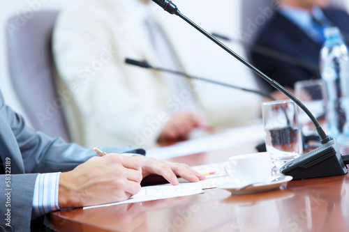 Photo: Hands of businessman writing with pen Hands of businessman writing with pen