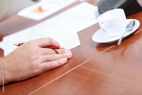 Photo: Hands of businessman laying on table Hands of businessman laying on table
