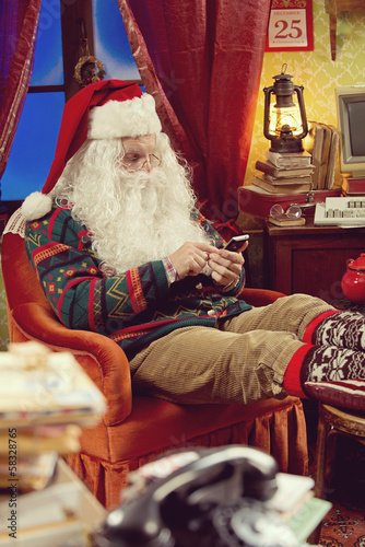 Photo: Santa Claus and smartphone Santa Claus and smartphone