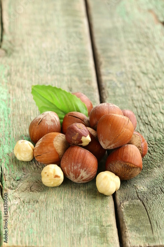 Photo: heap hazelnuts (filberts) on wooden background heap hazelnuts (filberts) on wooden background