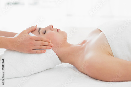 Photo: Hands massaging woman's face at beauty spa Hands massaging woman's face at beauty spa