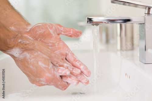 Photo: Washing hands with soap under running water Washing hands with soap under running water