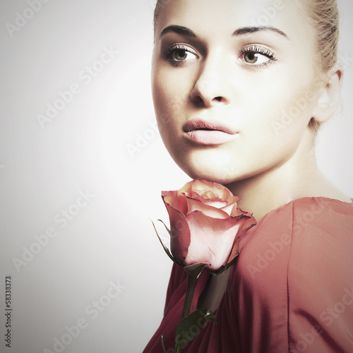 Photo: Portrait of girl and flower. beautiful woman in red dress Portrait of girl and flower. beautiful woman in red dress