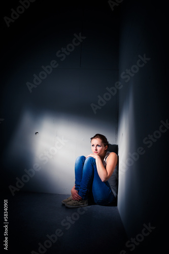 Photo: Young woman suffering from a severe depression Young woman suffering from a severe depression