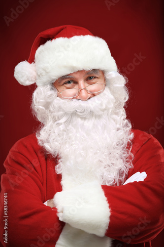 Photo: Photo of happy Santa Claus in eyeglasses looking at camera Photo of happy Santa Claus in eyeglasses looking at camera