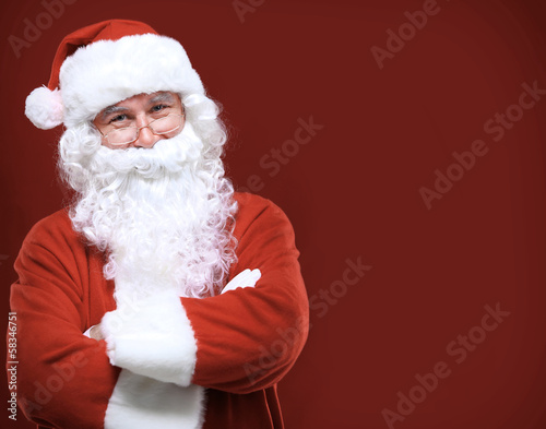 Photo: Photo of happy Santa Claus in eyeglasses looking at camera Photo of happy Santa Claus in eyeglasses looking at camera