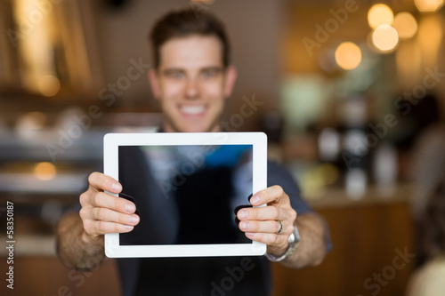 Photo: Cafe Owner Showing Digital Tablet Cafe Owner Showing Digital Tablet