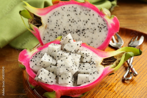 Photo: ripe sweet tropical dragon fruit on a wooden plate ripe sweet tropical dragon fruit on a wooden plate