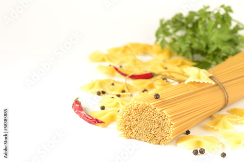 Photo: Pasta, spices and herbs on a white background Pasta, spices and herbs on a white background
