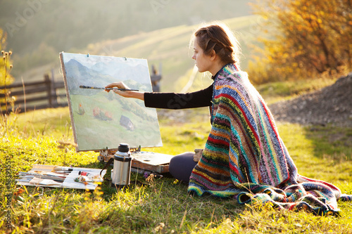 Photo: Young artist painting an autumn landscape Young artist painting an autumn landscape