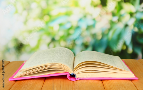 Photo: Opened book on bright background Opened book on bright background