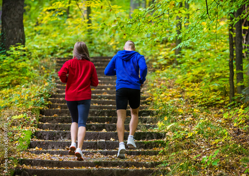 Photo: Healthy lifestyle - woman and man running in park Healthy lifestyle - woman and man running in park