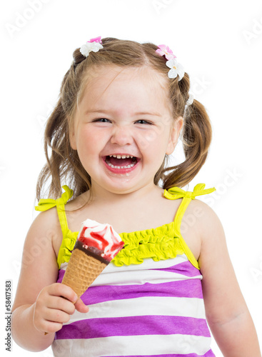 Photo: smiling kid girl eating ice cream isolated smiling kid girl eating ice cream isolated