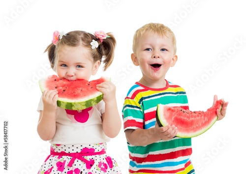 Photo: kids boy and girl eat watermelon isolated on white kids boy and girl eat watermelon isolated on white