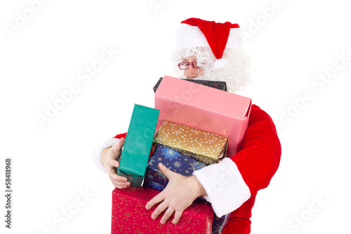Photo: Santa Claus carrying too much colourful gifts Santa Claus carrying too much colourful gifts