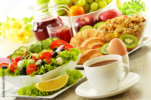 Photo: Breakfast with coffee, juice, croissant, salad, musli and egg Breakfast with coffee, juice, croissant, salad, musli and egg