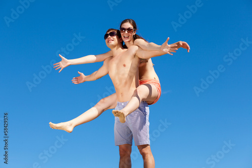 Photo: Happy Young Couple Together On The Beach Happy Young Couple Together On The Beach