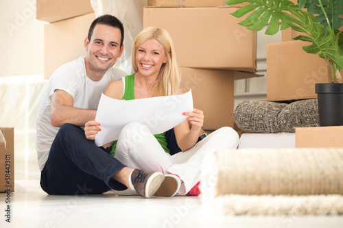Photo: Young happy couple moving into their new home Young happy couple moving into their new home