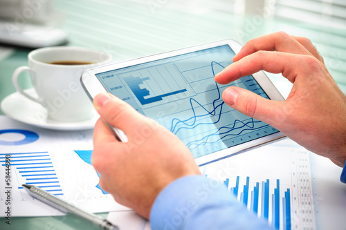 Photo: Businessman using tablet computer Businessman using tablet computer