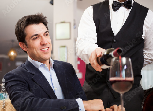 Photo: Waiter pouring wine Waiter pouring wine