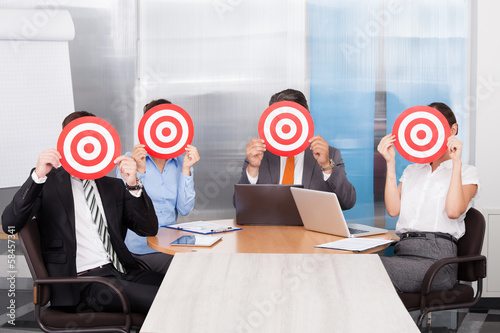 Photo: Businesspeople Holding Dartboard Businesspeople Holding Dartboard