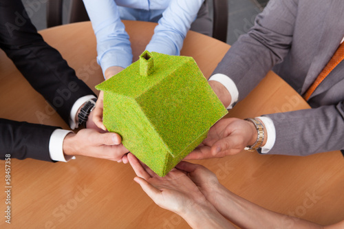 Photo: Business People's Hand Holding House Business People's Hand Holding House