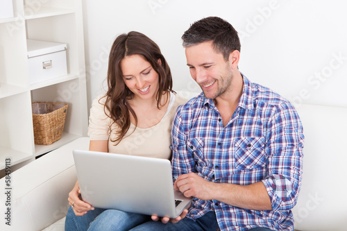 Photo: Couple Looking At Laptop Couple Looking At Laptop
