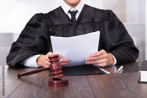 Photo: Judge Holding Documents Judge Holding Documents