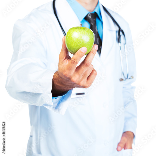 Photo: Doctor's hand holding a fresh green apple close-up on white Doctor's hand holding a fresh green apple close-up on white