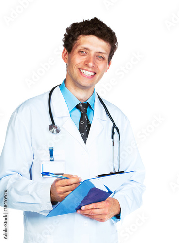Photo: Portrait of smiling young male doctor writing on a patient's med Portrait of smiling young male doctor writing on a patient's med