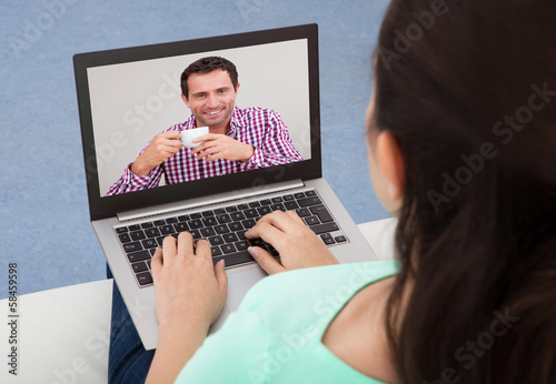 Photo: Woman Video Chatting On Laptop Woman Video Chatting On Laptop