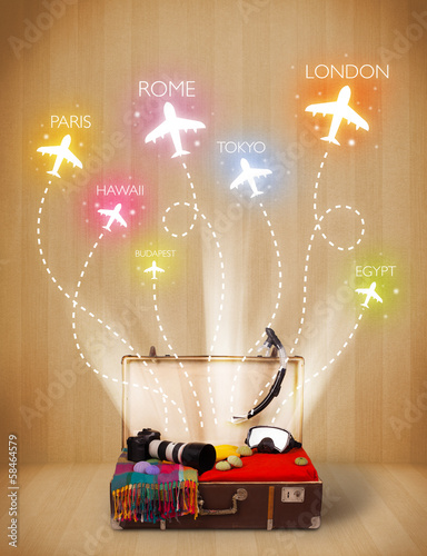 Photo: Travel bag with clothes and colorful planes flying out Travel bag with clothes and colorful planes flying out