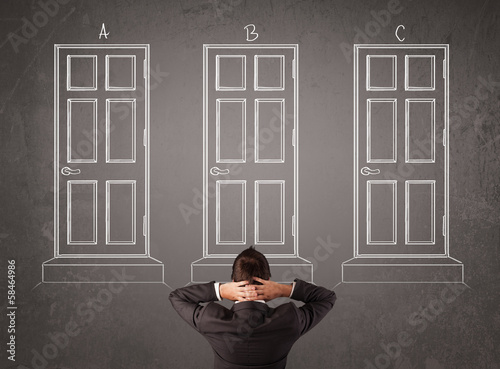 Photo: Businessman choosing the right door Businessman choosing the right door