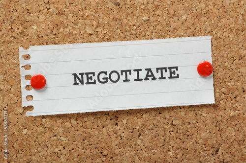 Photo: The word Negotiate on a cork notice board The word Negotiate on a cork notice board