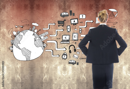 Photo: Composite image of businesswoman standing with hands on hips Composite image of businesswoman standing with hands on hips