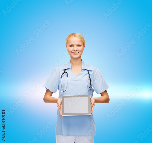 Photo: smiling female doctor or nurse with tablet pc smiling female doctor or nurse with tablet pc