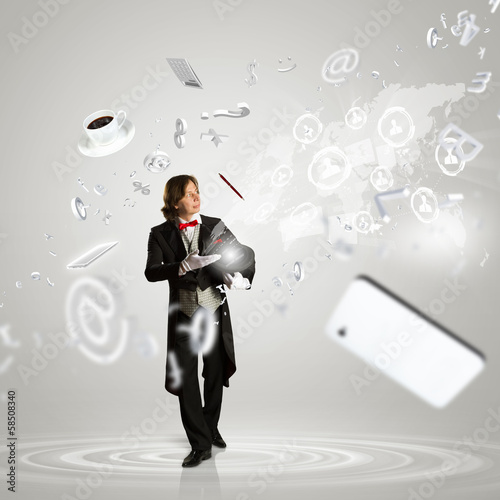 Photo: Magician and computer devices Magician and computer devices