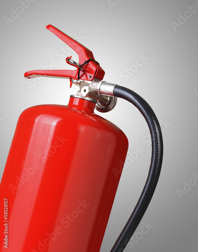 Photo: fire extinguisher on gray background fire extinguisher on gray background