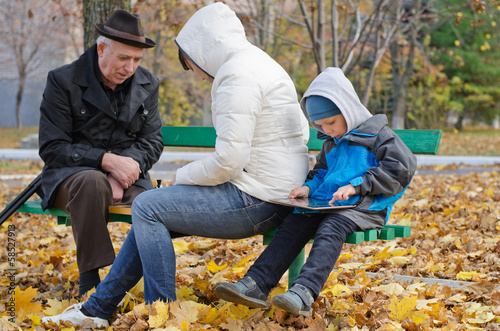 Photo: Family spending an autumn day in the park Family spending an autumn day in the park