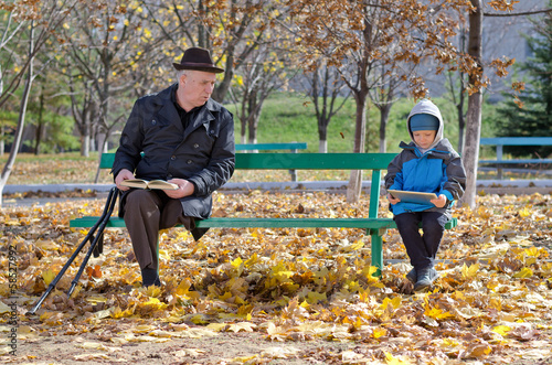 Photo: Grandfather watching over his young grandson Grandfather watching over his young grandson