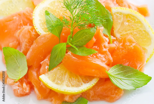 Photo: fresh salmon with lemon on the white plate fresh salmon with lemon on the white plate